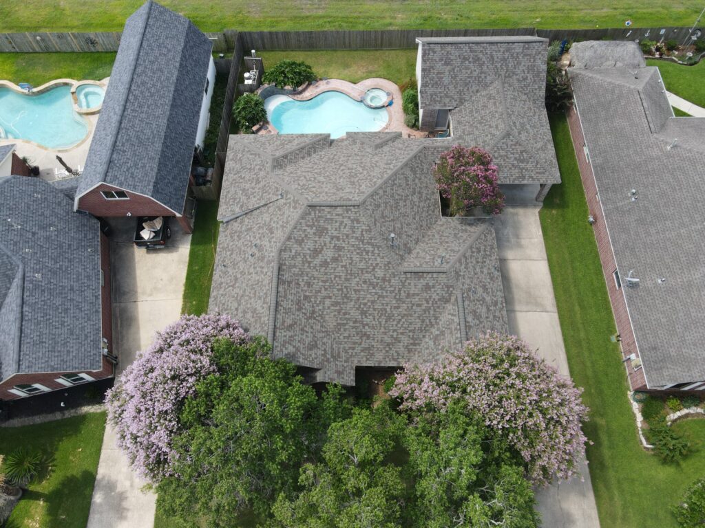 30-year architectural shingle roof with ridge vent and painted pipe jacks.