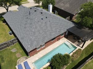 30-year architectural shingle roof with ridge vent and painted pipe jacks.