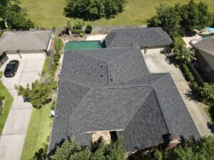 30-year architectural shingle roof with ridge vent and painted pipe jacks.