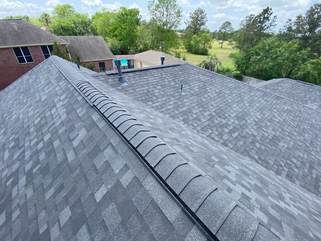 30-year architectural shingle roof with ridge vent and painted pipe jacks.
