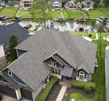 30-year architectural shingle roof with ridge vent and painted pipe jacks.